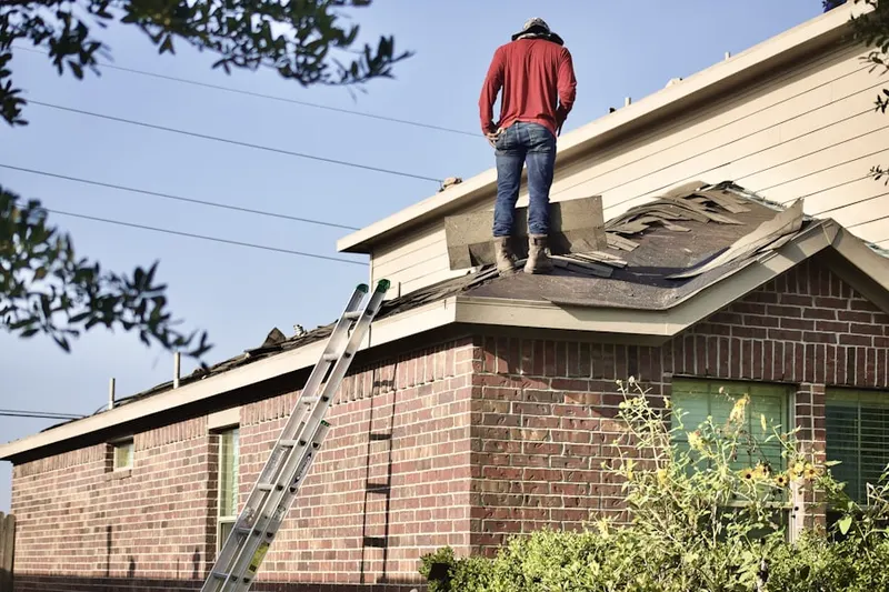 Professional roofer working on a residential roof in Paulina